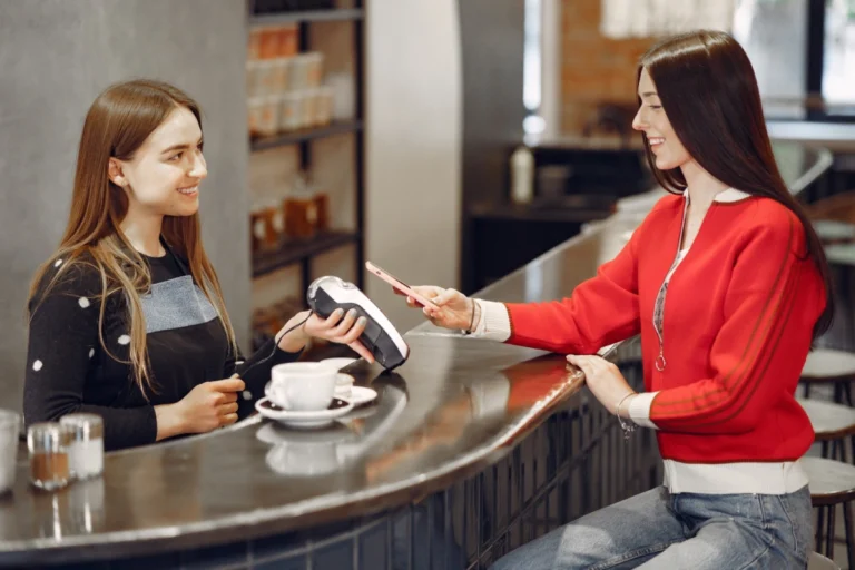 girl-paying-her-latte-with-smartphone-by-contactless-pay-pass-technology_1157-36658